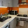 View of the kitchen showing the gaz stove, microwave, oven, sink, dish washer and cabinets