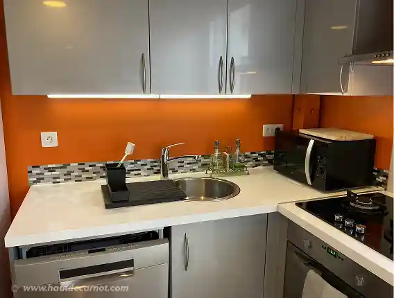 View of the kitchen showing the gaz stove, microwave, oven, sink, dish washer and cabinets