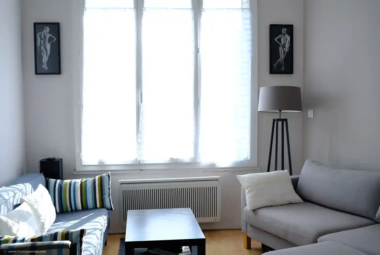 Morning light shines through the large living room window. Enjoy it from one of the couches.