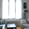 Morning light shines through the large living room window. Enjoy it from one of the couches.