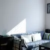 One of the couches in the living room, bathed in sunshine in the morning is a nice place to relax and read